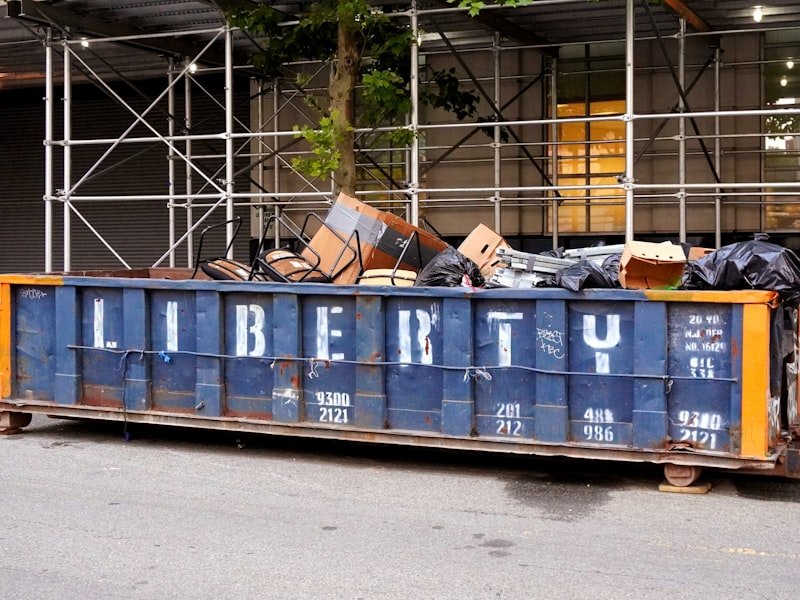 Loaded 6-yard mixed-waste bin filled with old furniture and renovation debris