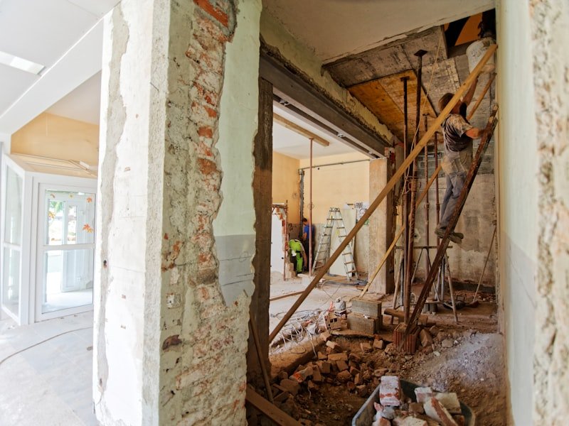 Mid-renovation interior with exposed brick and timber, the kind of job a 15-yard roll-off handles